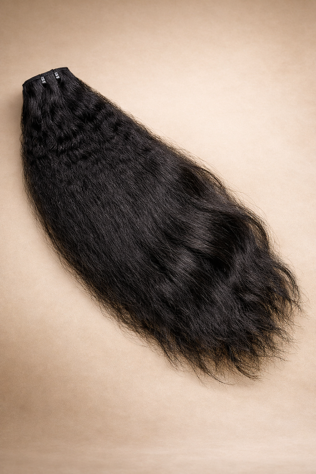 Black fur hairpiece on a beige background