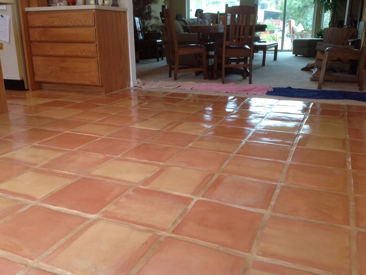 A tiled floor in a room with a table and chairs