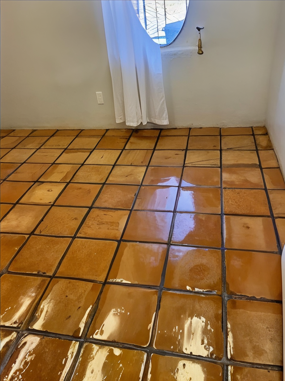 A before and after photo of a tile floor