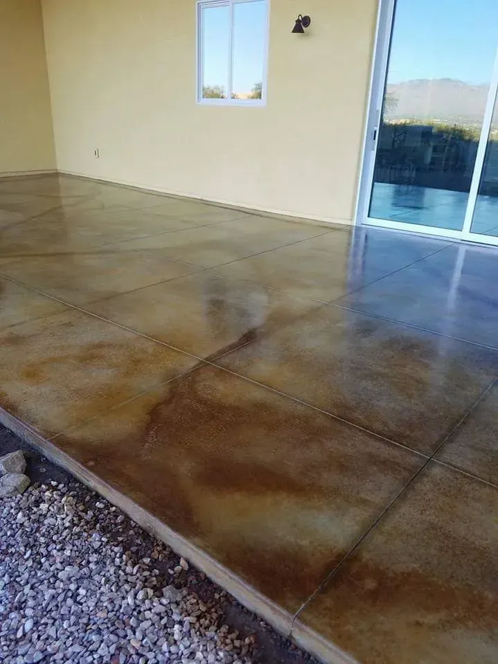 A concrete floor in a room with a sliding glass door.