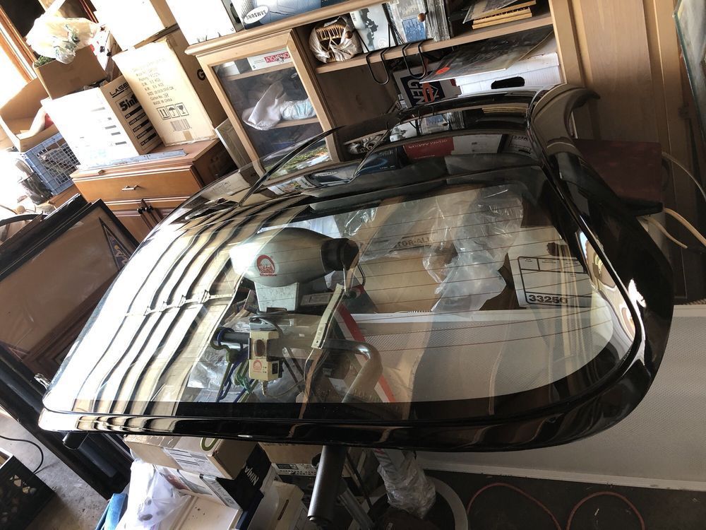 A car windshield is sitting on a table in a room.