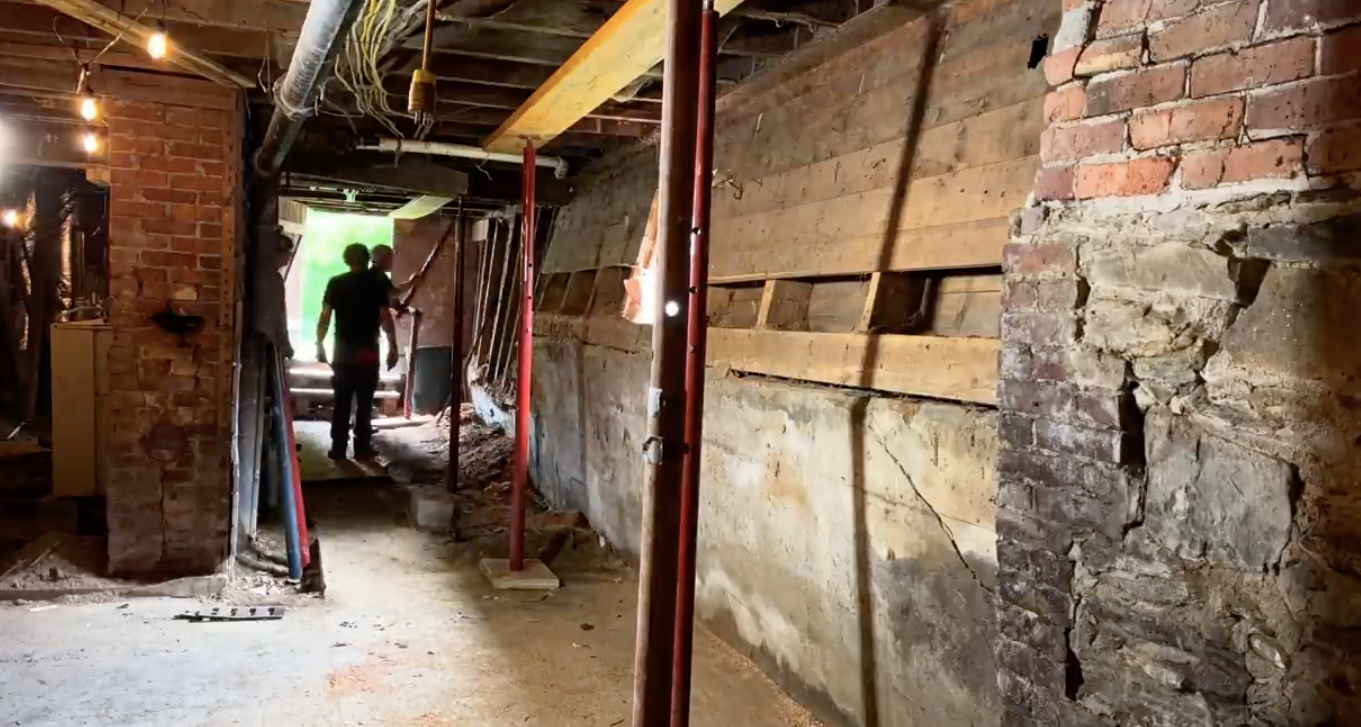 Bowing foundation wall showing signs of pressure and structural damage
