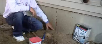 Foundation repair specialist inspecting a crack in a home's foundation in Cape Breton