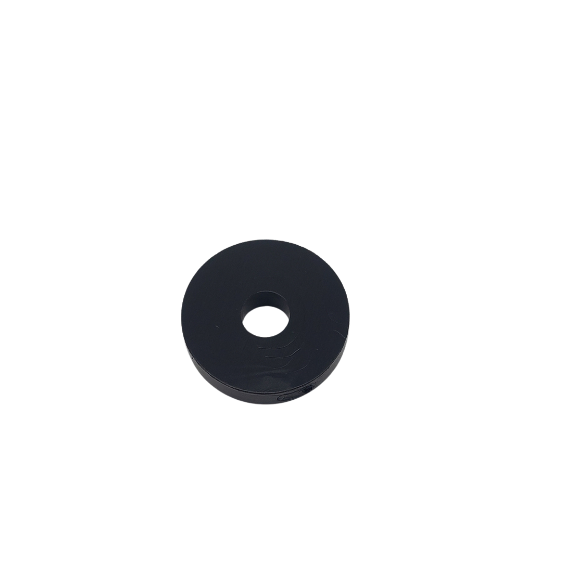 Black rubber washer with a center hole on a white background