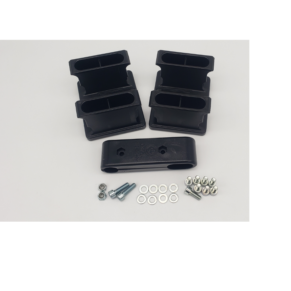 Black plastic mounting brackets with screws, washers, and bolts arranged on a white background