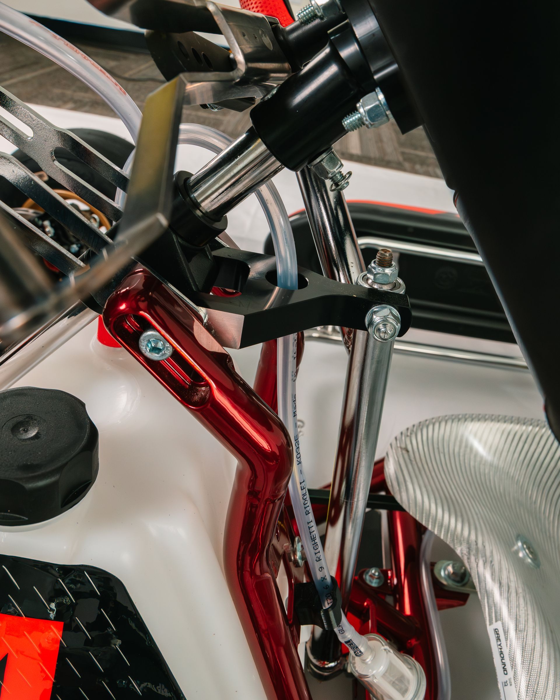 Red and black go-kart with large rear spoiler on a white background