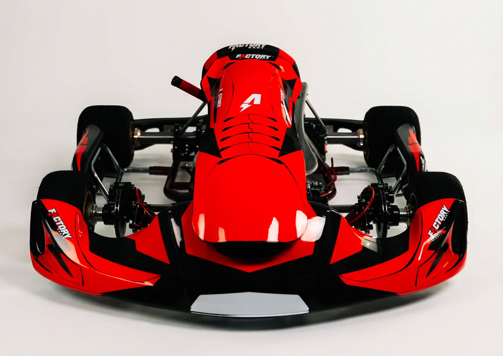 Red Formula-style race car viewed from the front on a white background