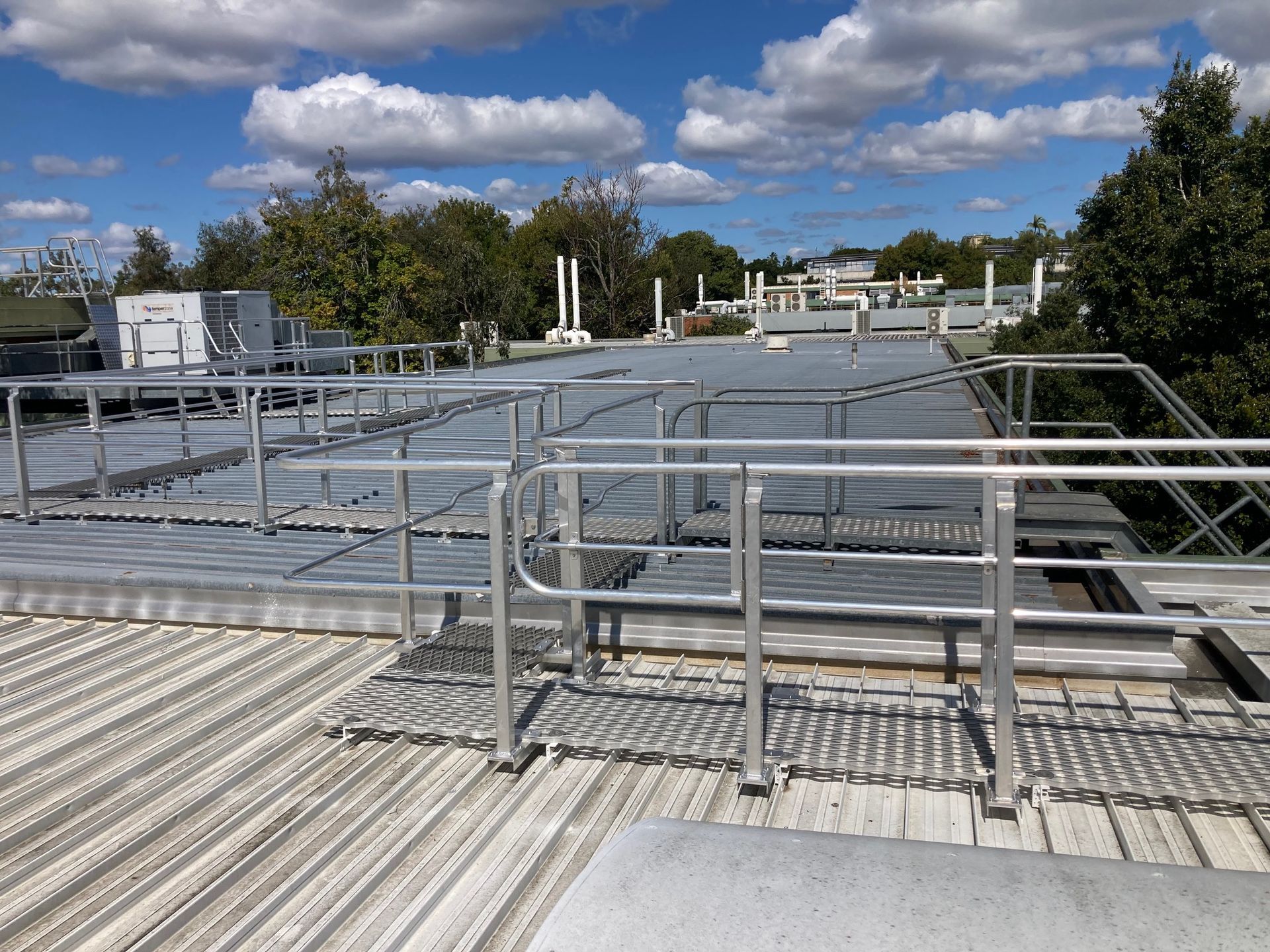 There is a metal railing on the roof of a building.