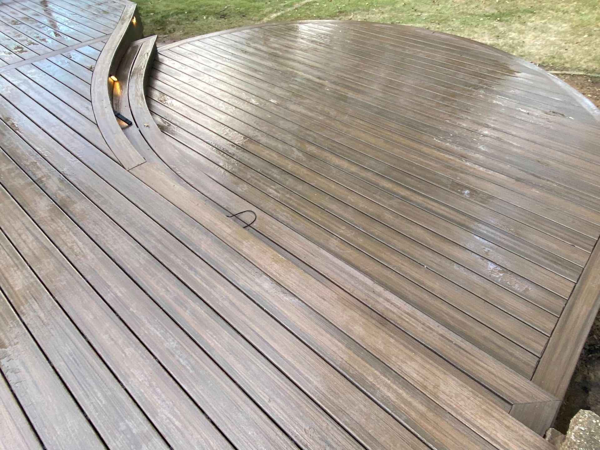 A wooden deck with stairs leading up to it.