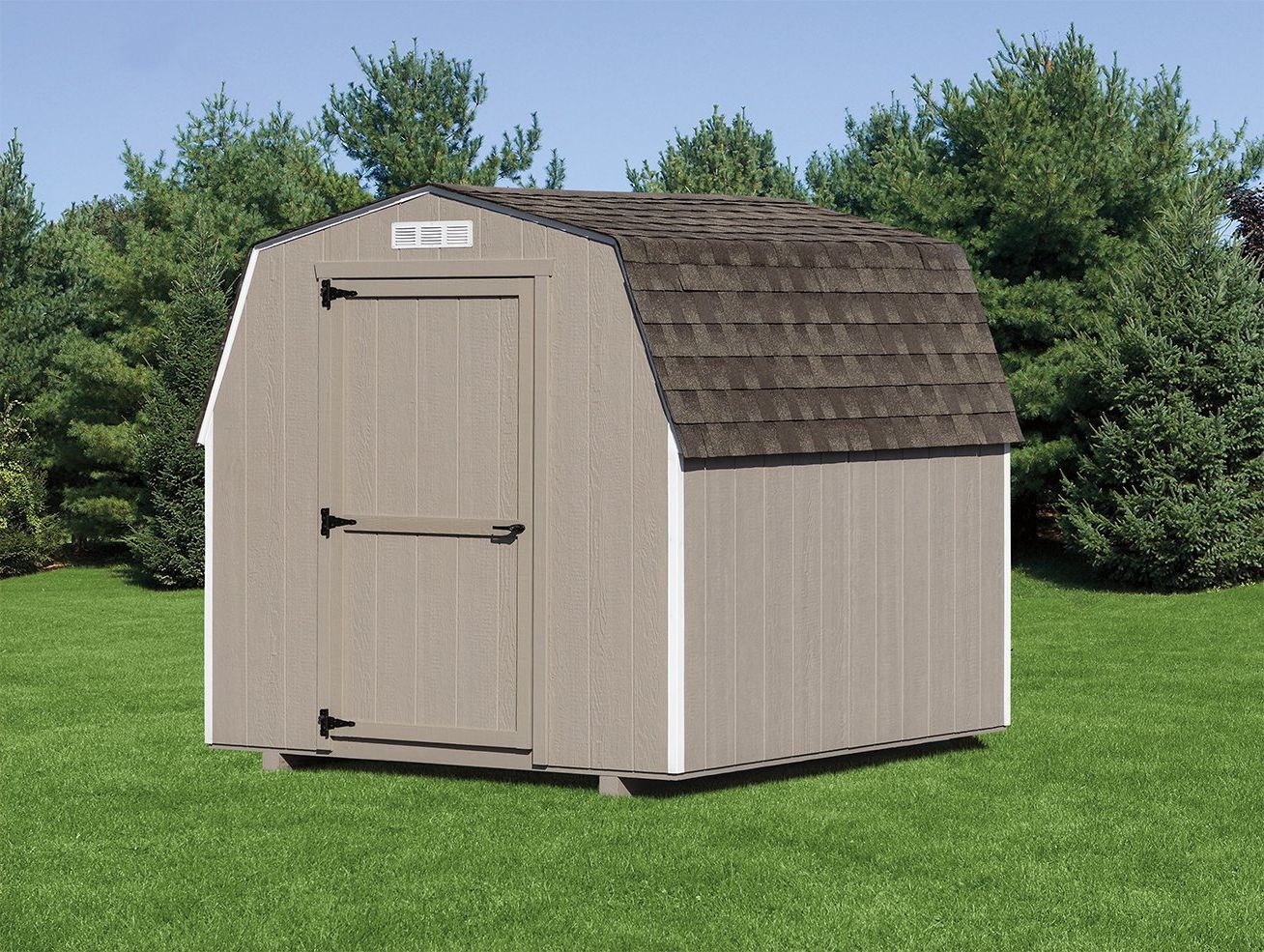 Light brown wood shed with a barn-style roof, matching single-entry door, brown asphalt roofing, white trim, and a white gable vent.