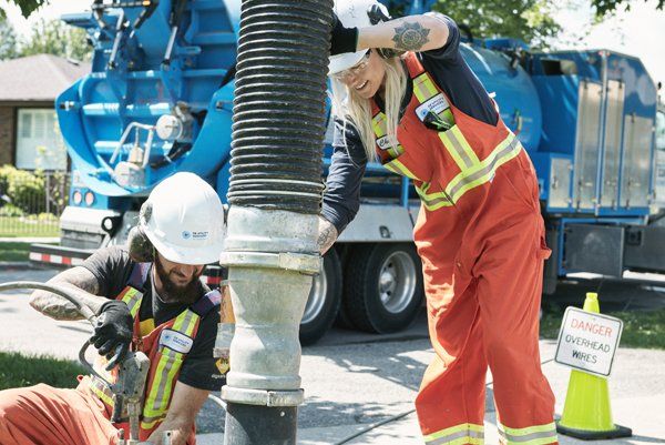 Workers performing hydro excavation