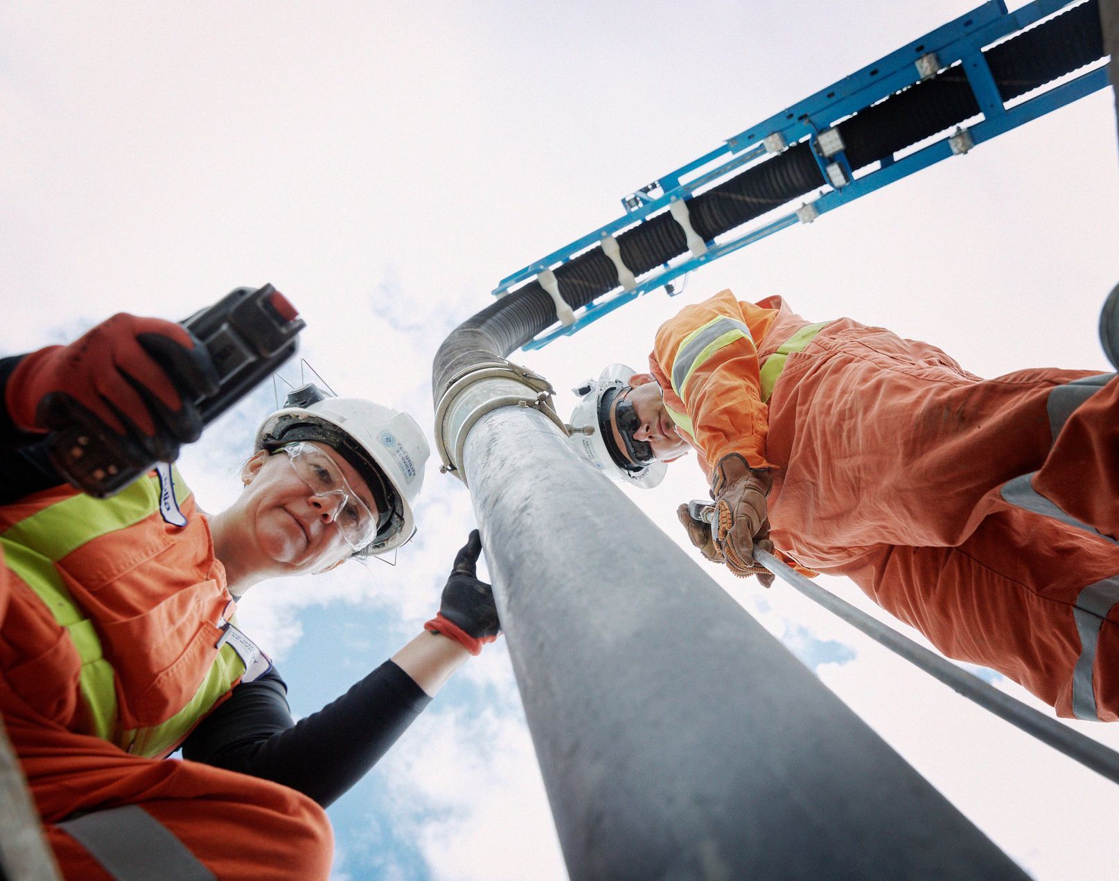 Workers looking down a hole