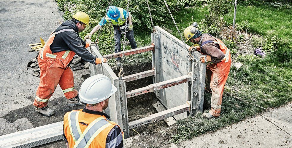 Workers setting up a temporary structure in a hole