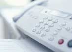 White office telephone keypad close-up with a red button