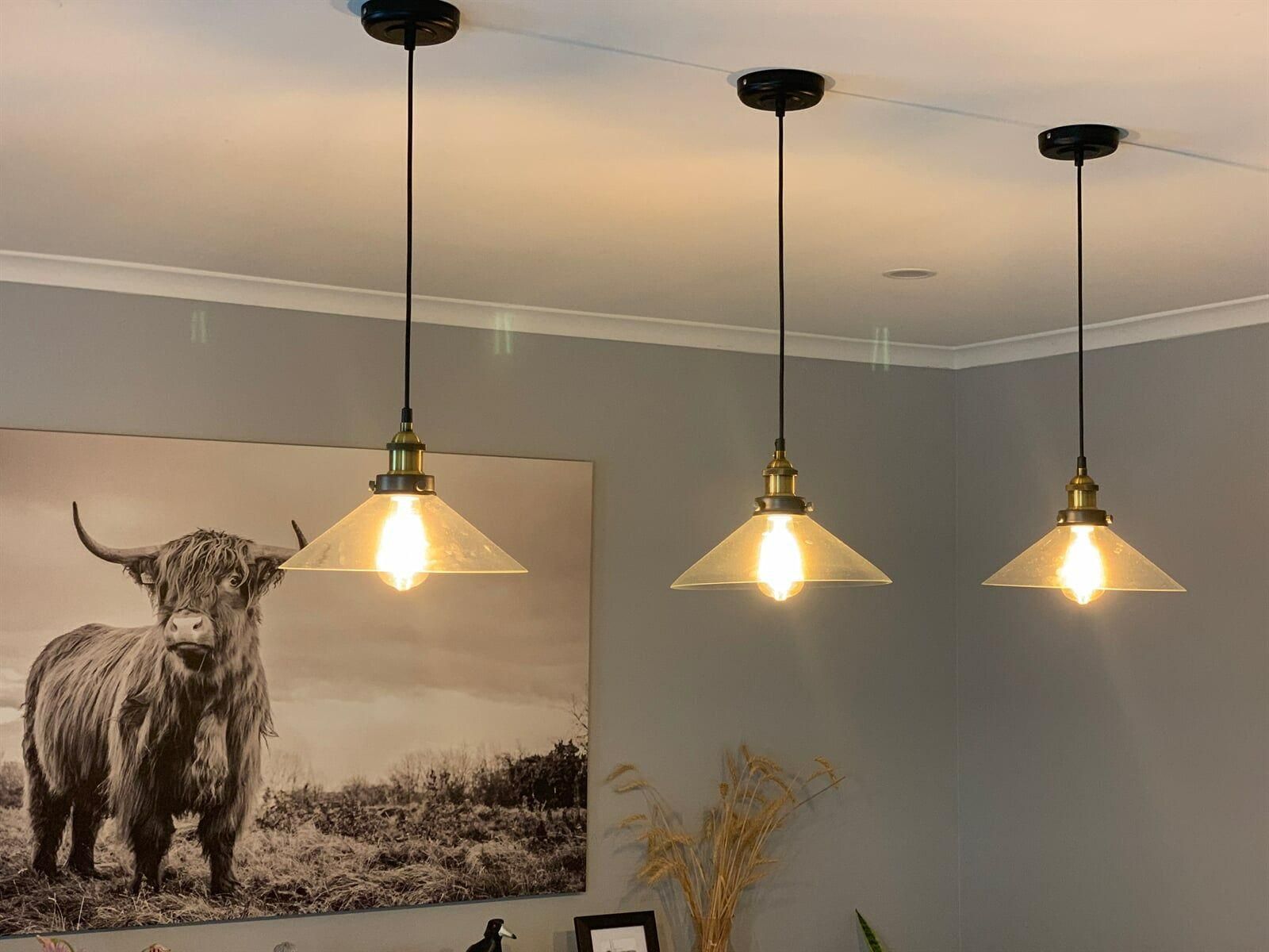 Three Pendant Lights Are Hanging From The Ceiling In A Room — DG Electrical & Fire In Shoalhaven, NSW
