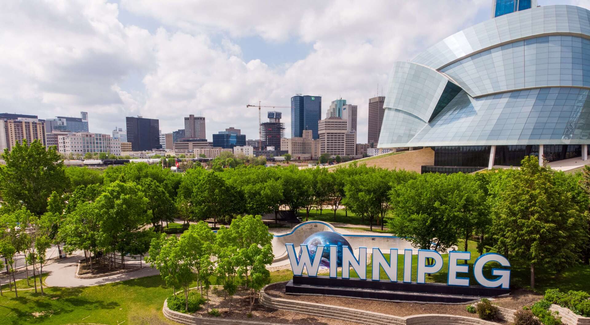 Winnipeg sign with Museum for Human Rights in the background