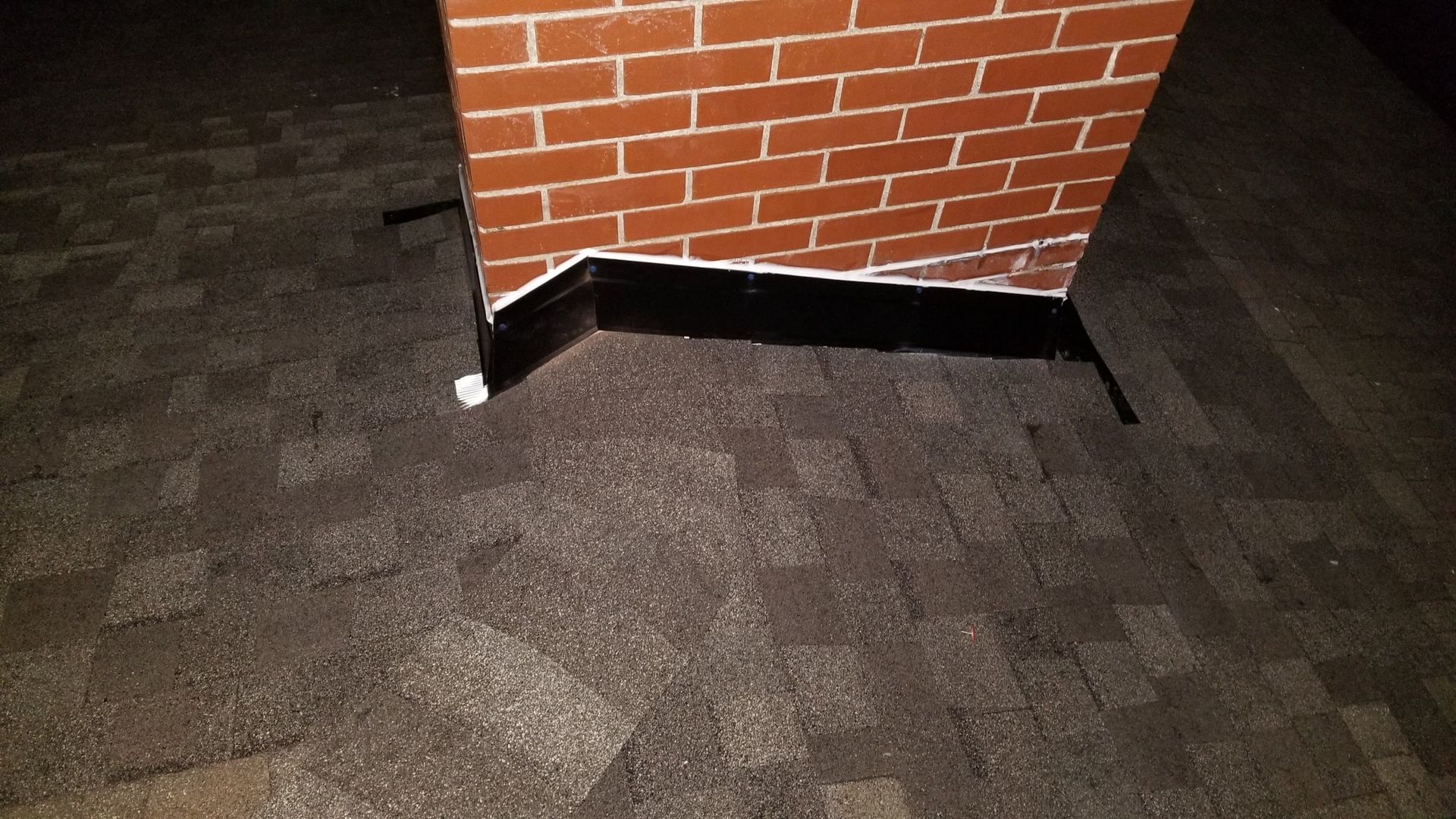 A brick chimney is sitting on top of a brick floor.