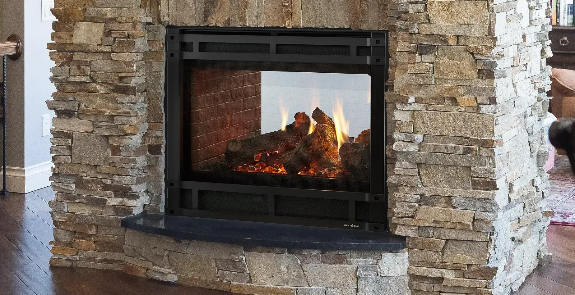 A fireplace in a living room with a brick wall