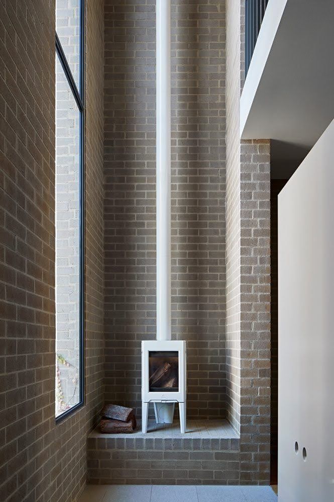 There is a fireplace in the corner of the room.