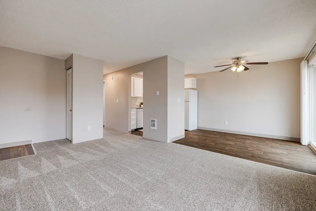 Photo of a living room showing the width of the dining area next to it