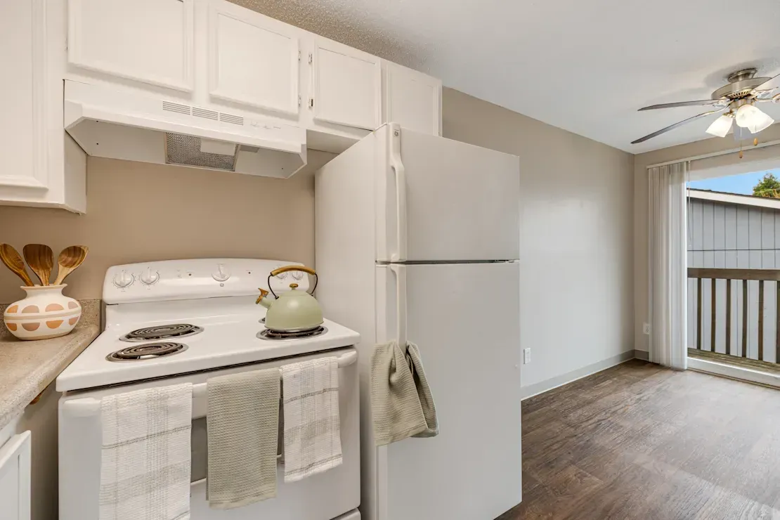 Photo of a kitchen with the dining area in the background