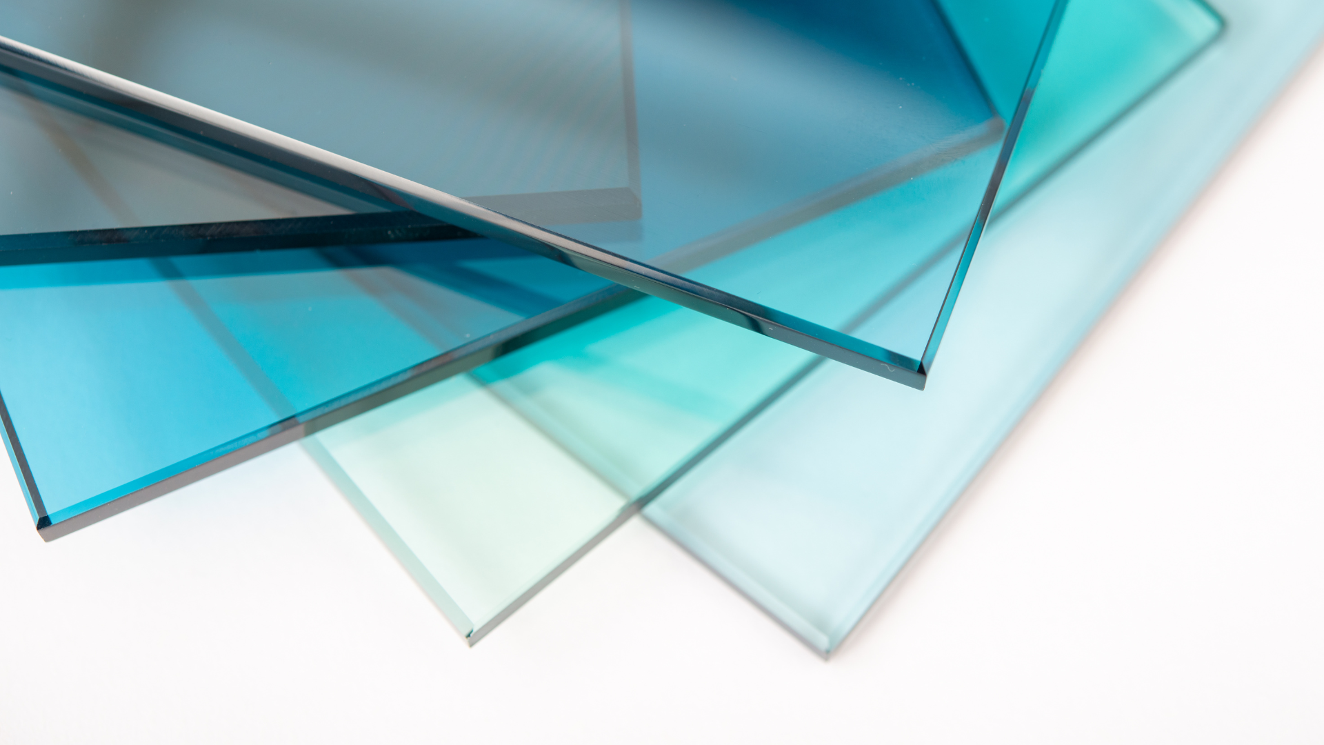 Three different colored glass sheets are stacked on top of each other