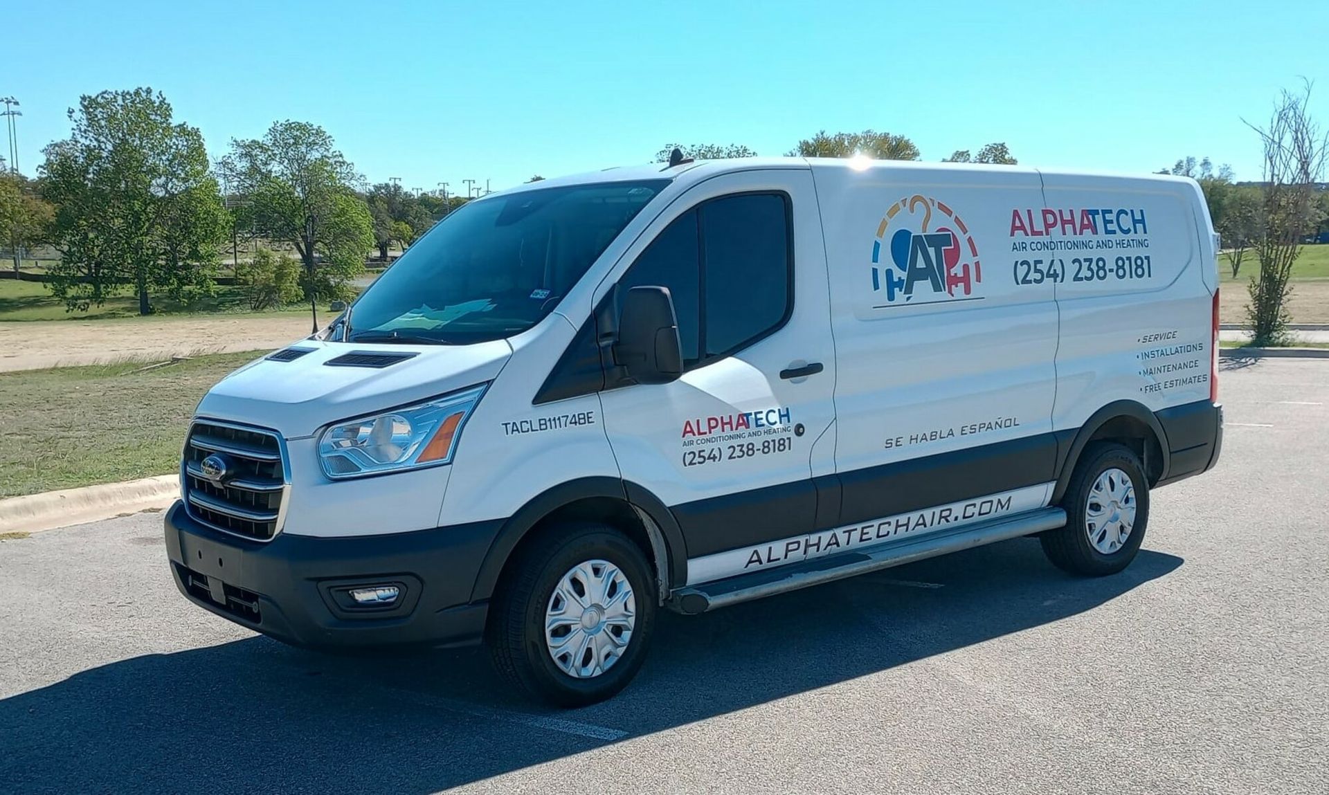 a white van is parked on the side of the road .