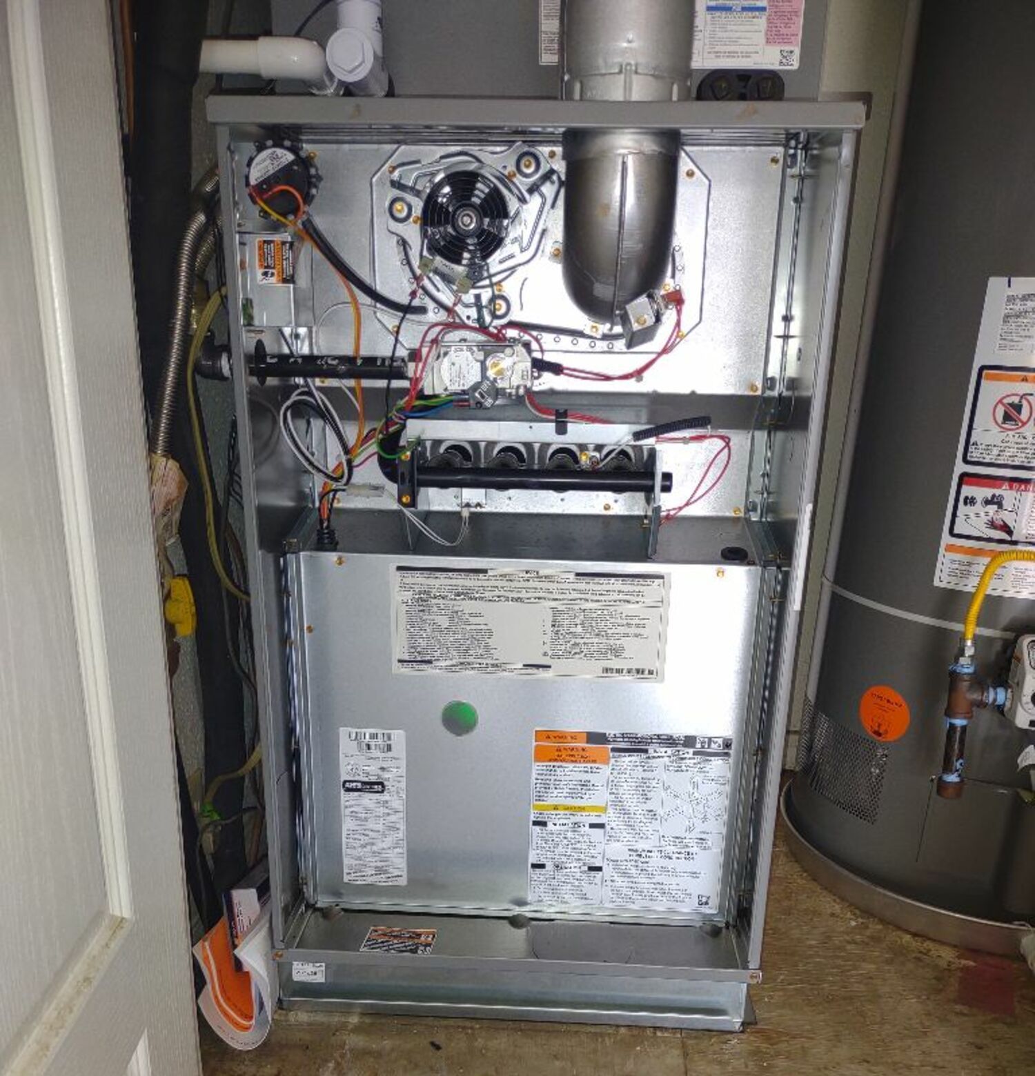 the inside of an air conditioner with a water heater next to it