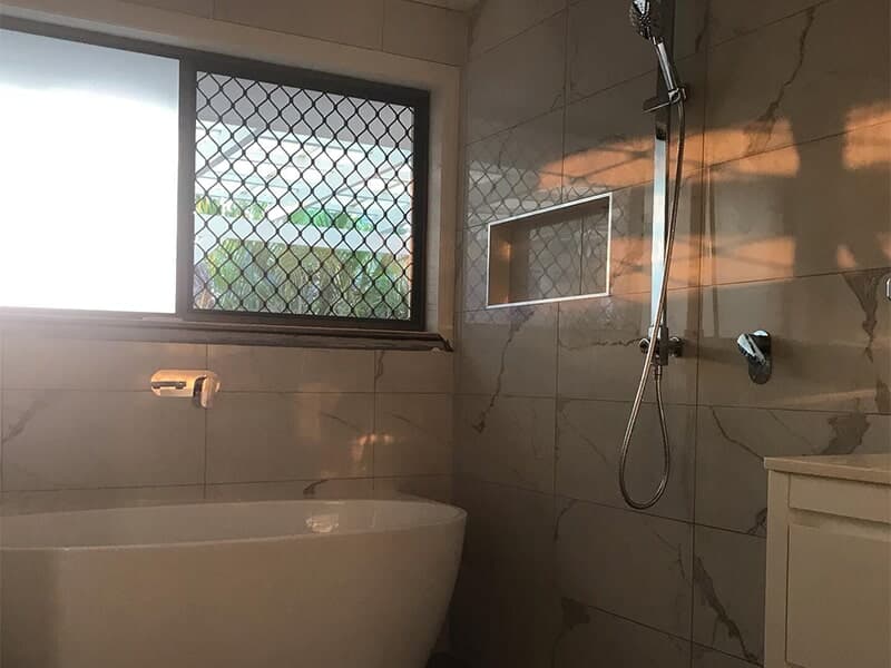 Modern Bathroom With White Tiles — Rossi Plumbing in Gold Coast, QLD