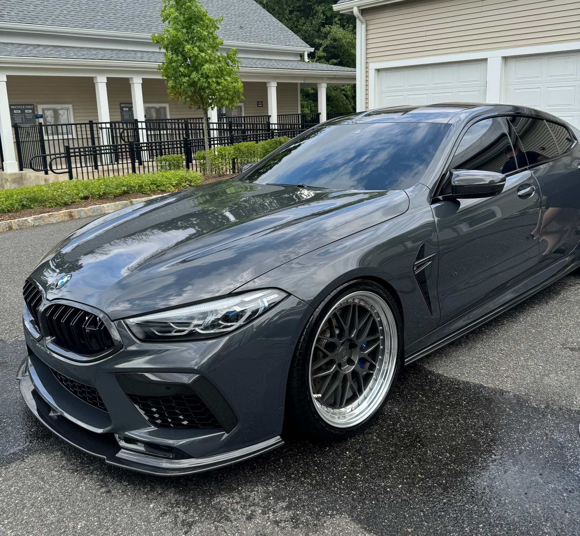 A gray bmw m6 is parked in front of a house.