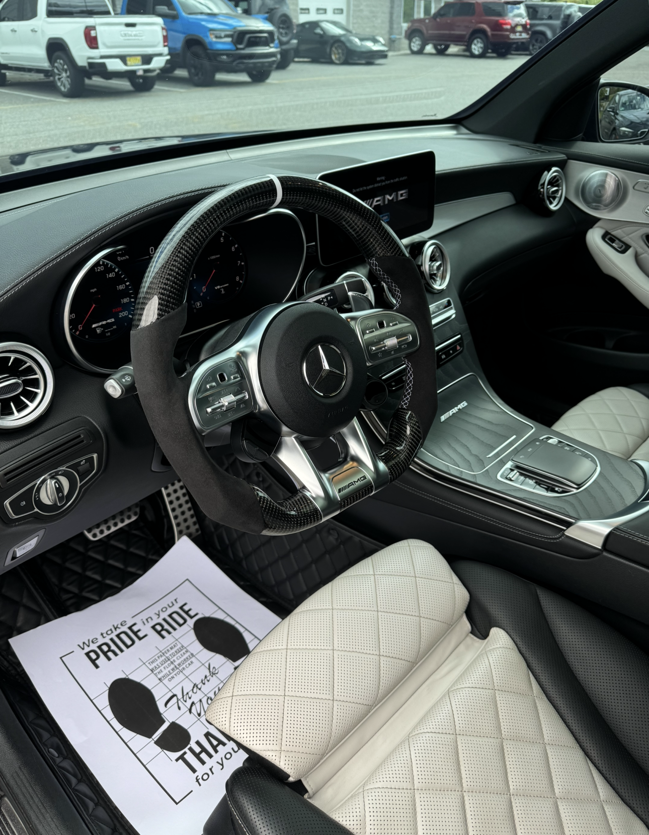 The inside of a Mercedes with a paper that says pride ride.