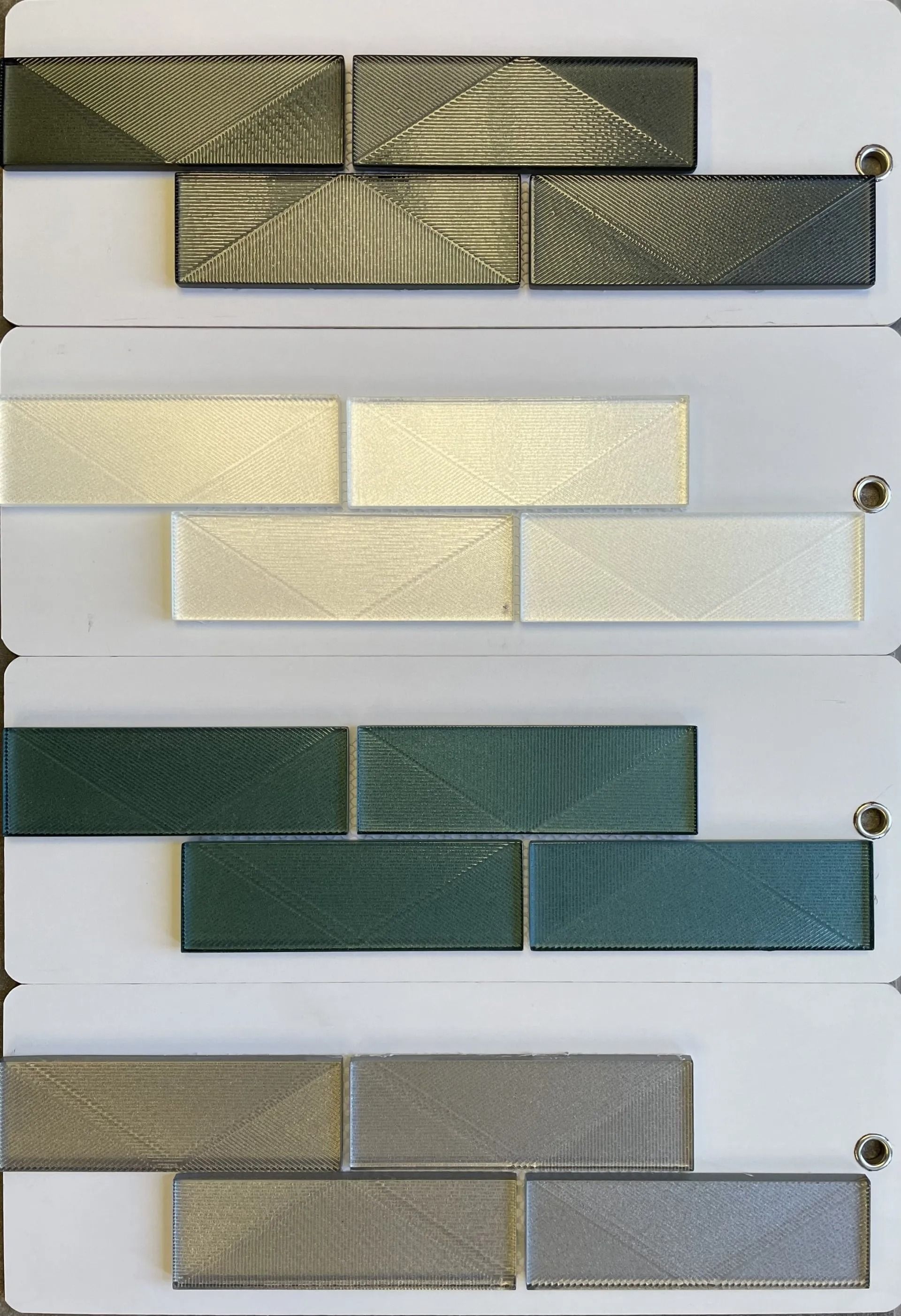 Stacked decorative ribbon samples in gold, cream, green, and gray tones