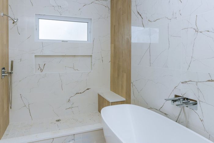 a bathroom with white bath