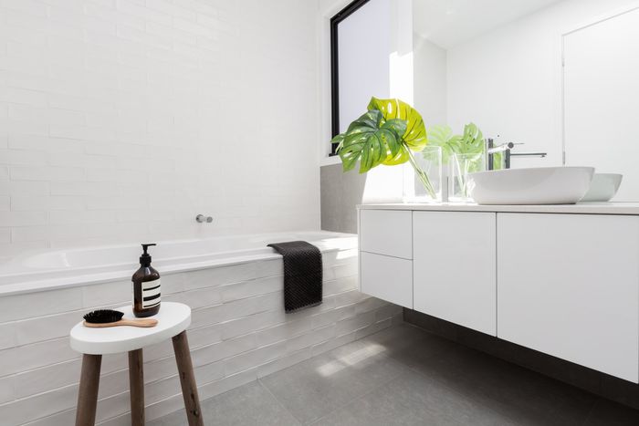 a bathroom with white marled wall
