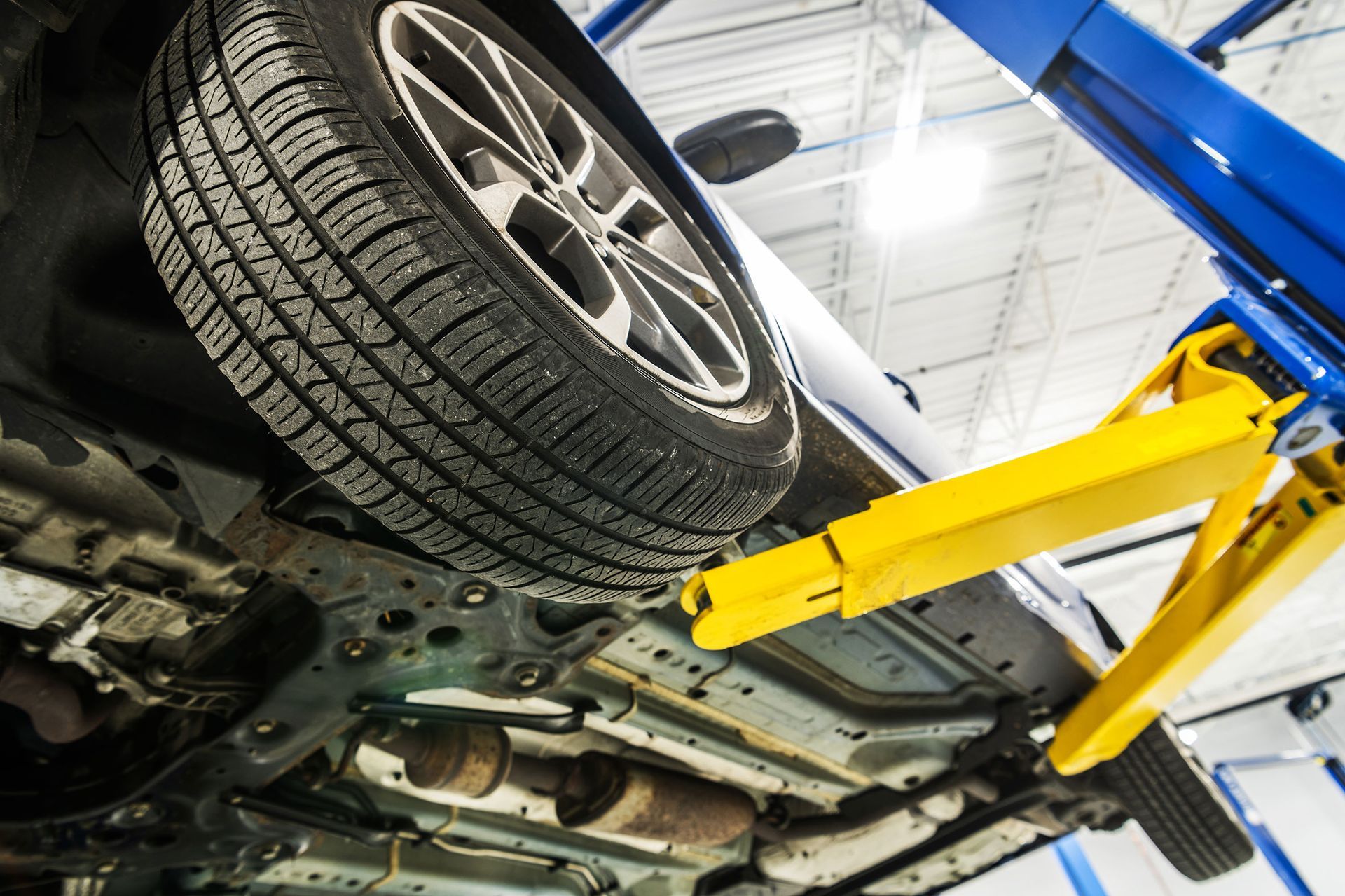 Technician performing summer car maintenance services in Florida shop