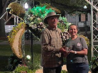 Couple in Front of Flower Arrangement – Mobile, AL – A Bloom Garden Center