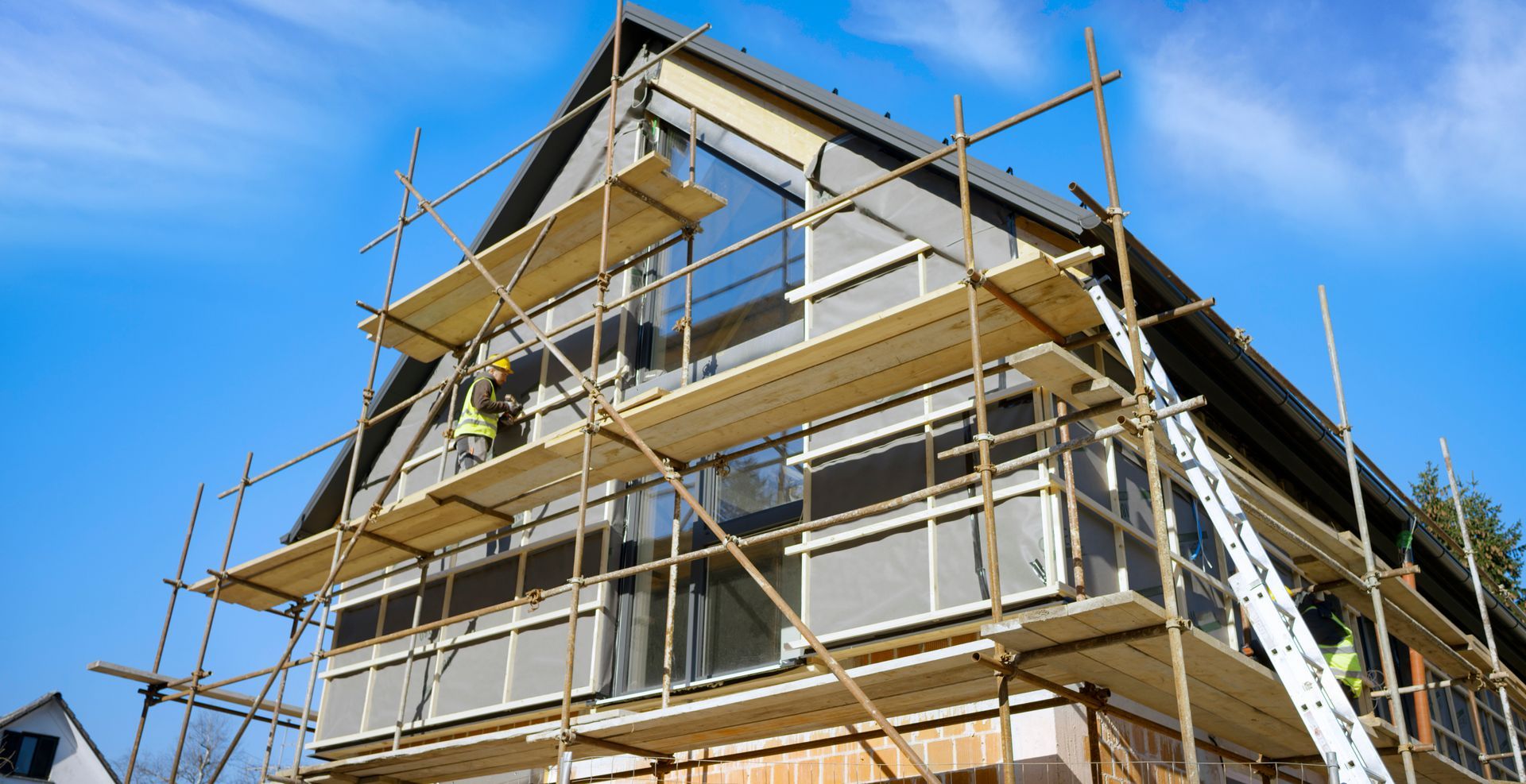 A house is being built with scaffolding around it.