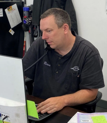 A person talking on the phone | HMI Auto Care