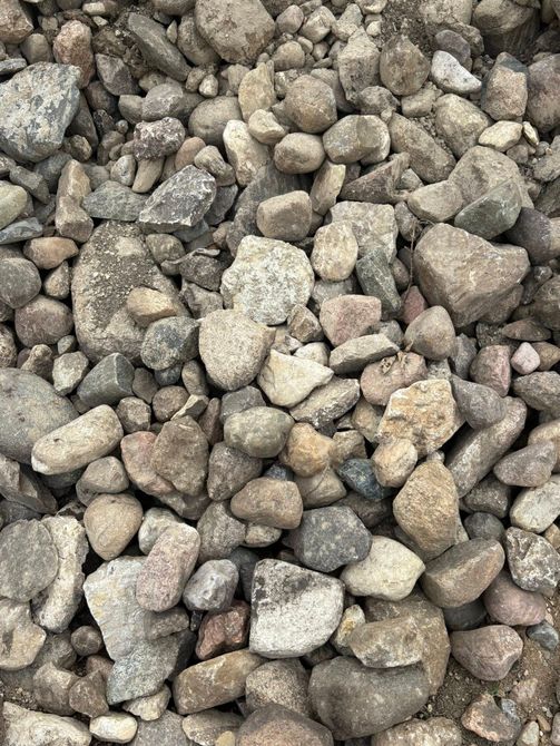 Pile of small gray and tan rocks or gravel filling the frame
