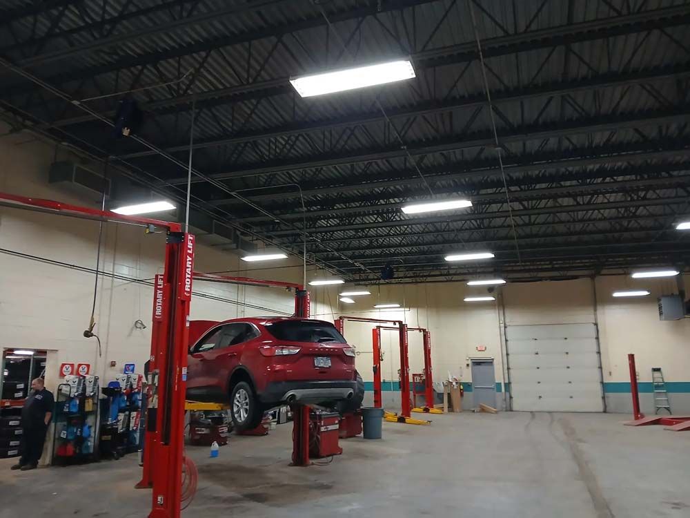 A store with a lot of lights hanging from the ceiling.