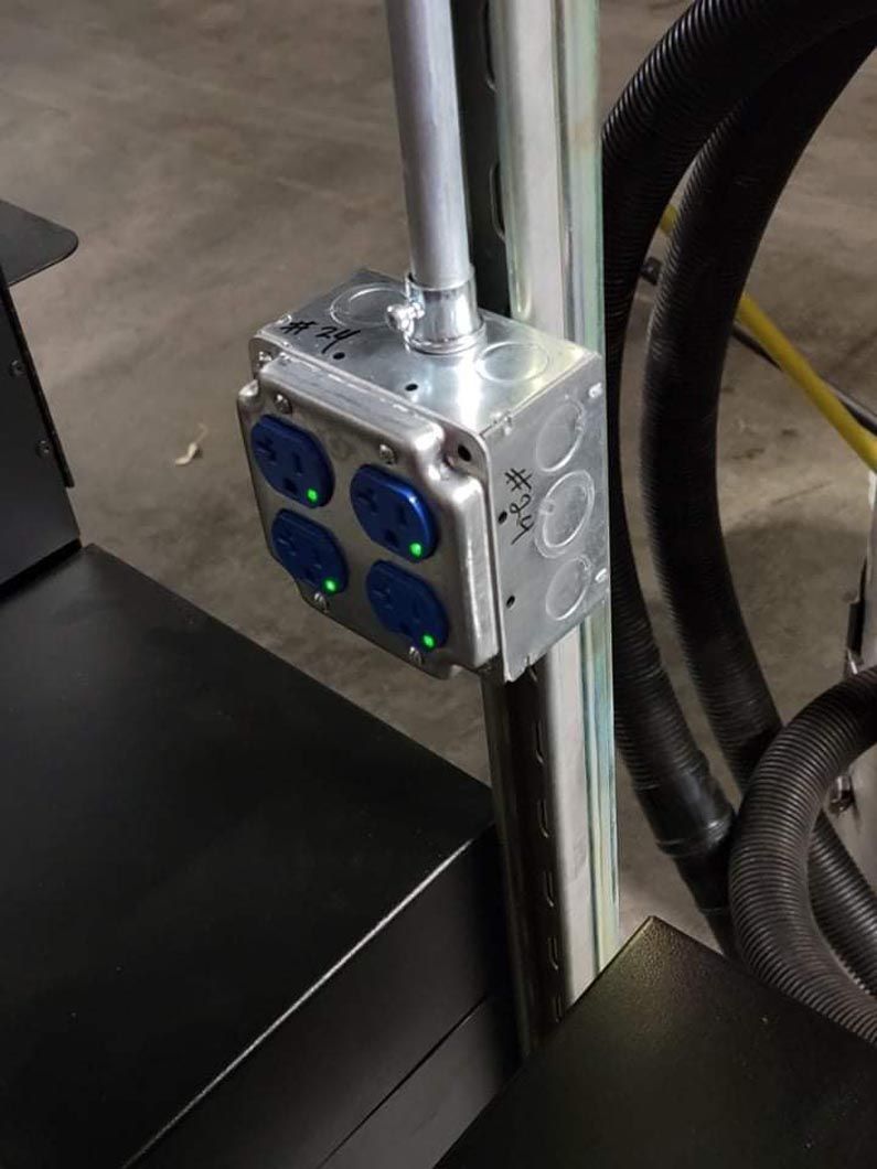 A close up of a power outlet on a pole.