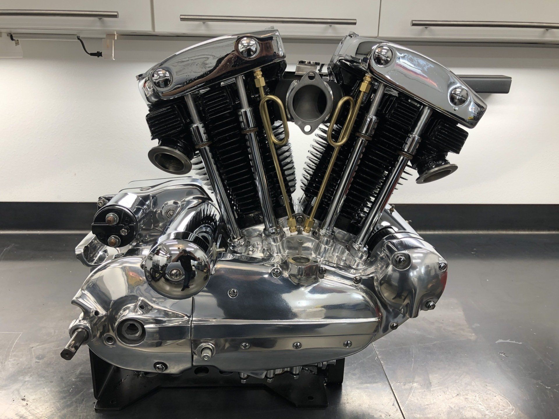 Chrome V-twin engine on a showroom floor, with polished metal and black fins.