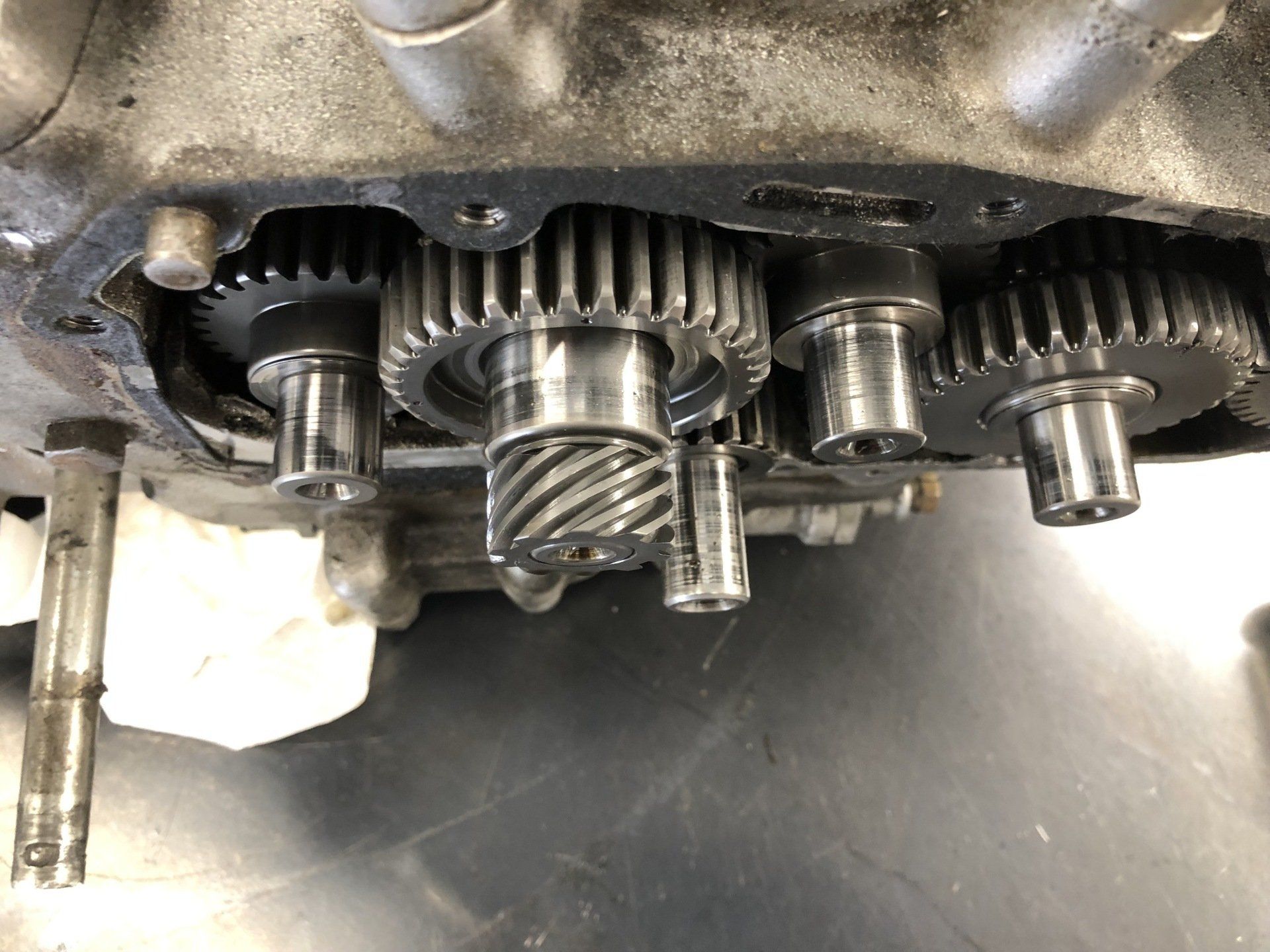 Close-up of exposed metal gears and shafts inside a mechanical gearbox casing.