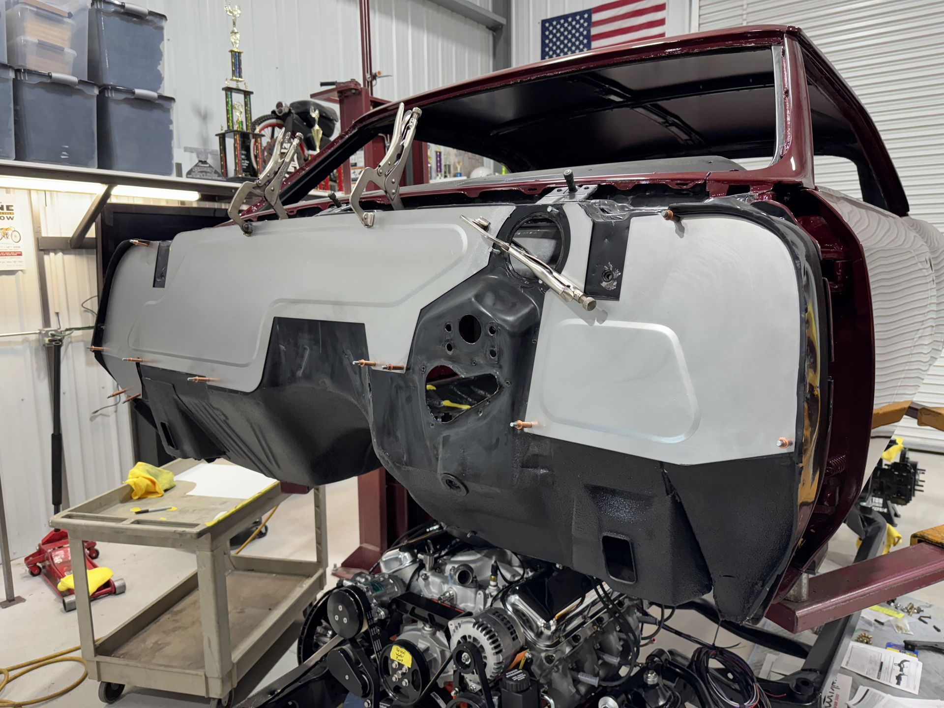 Damaged vehicle cockpit in a workshop, with exposed interior and detached front panels