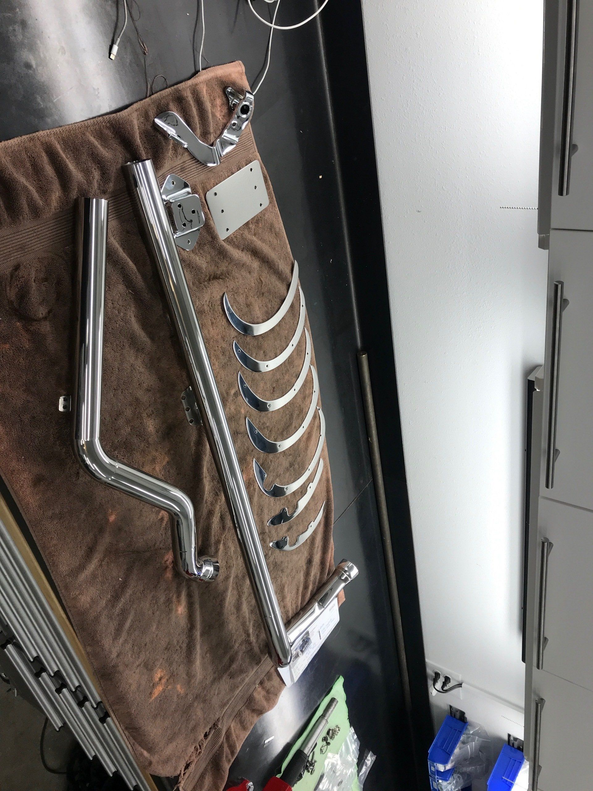 Brown beaded clutch purse with silver trim resting on a table near a window.