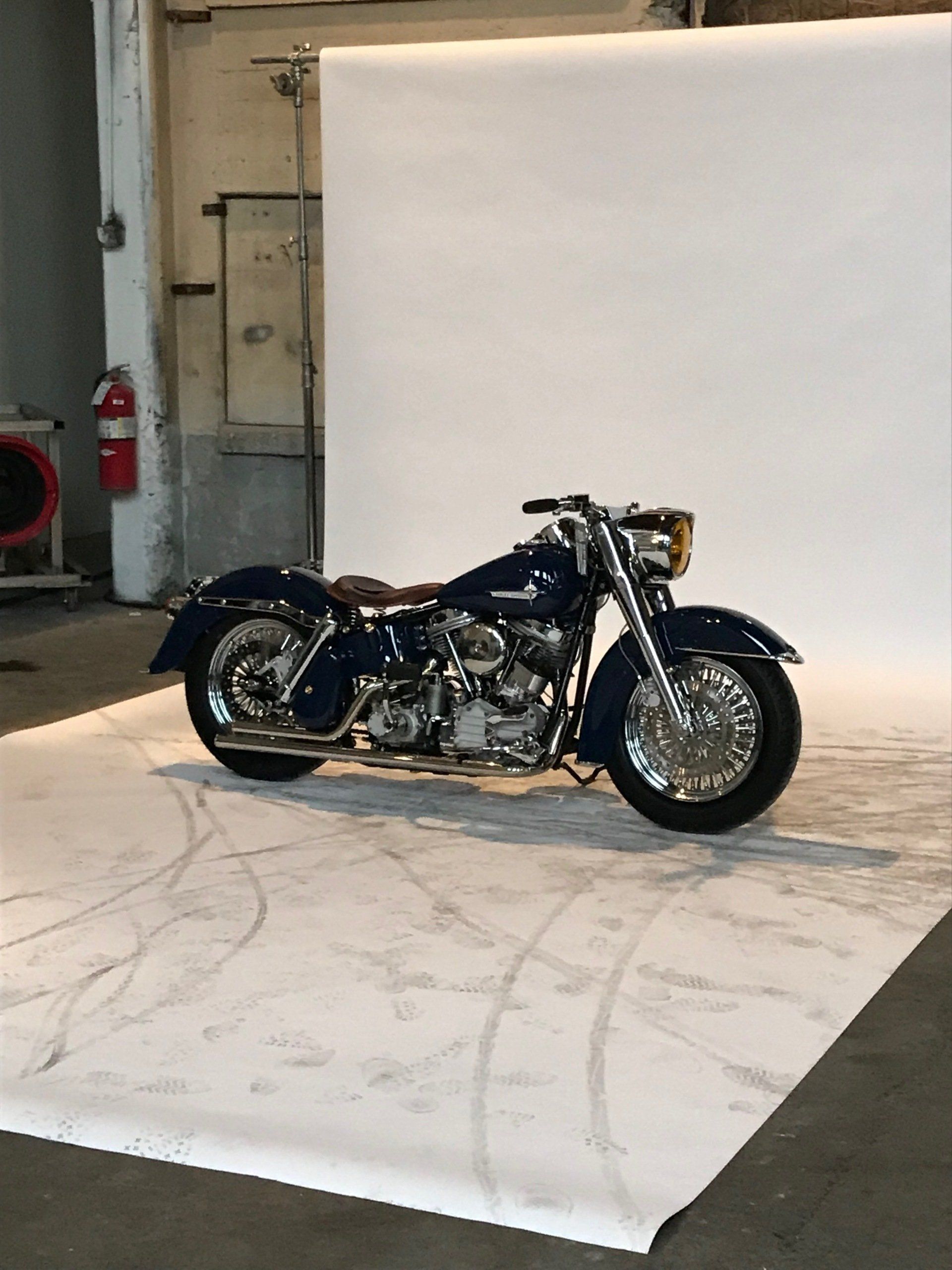 Black motorcycle on a white backdrop in a studio setting
