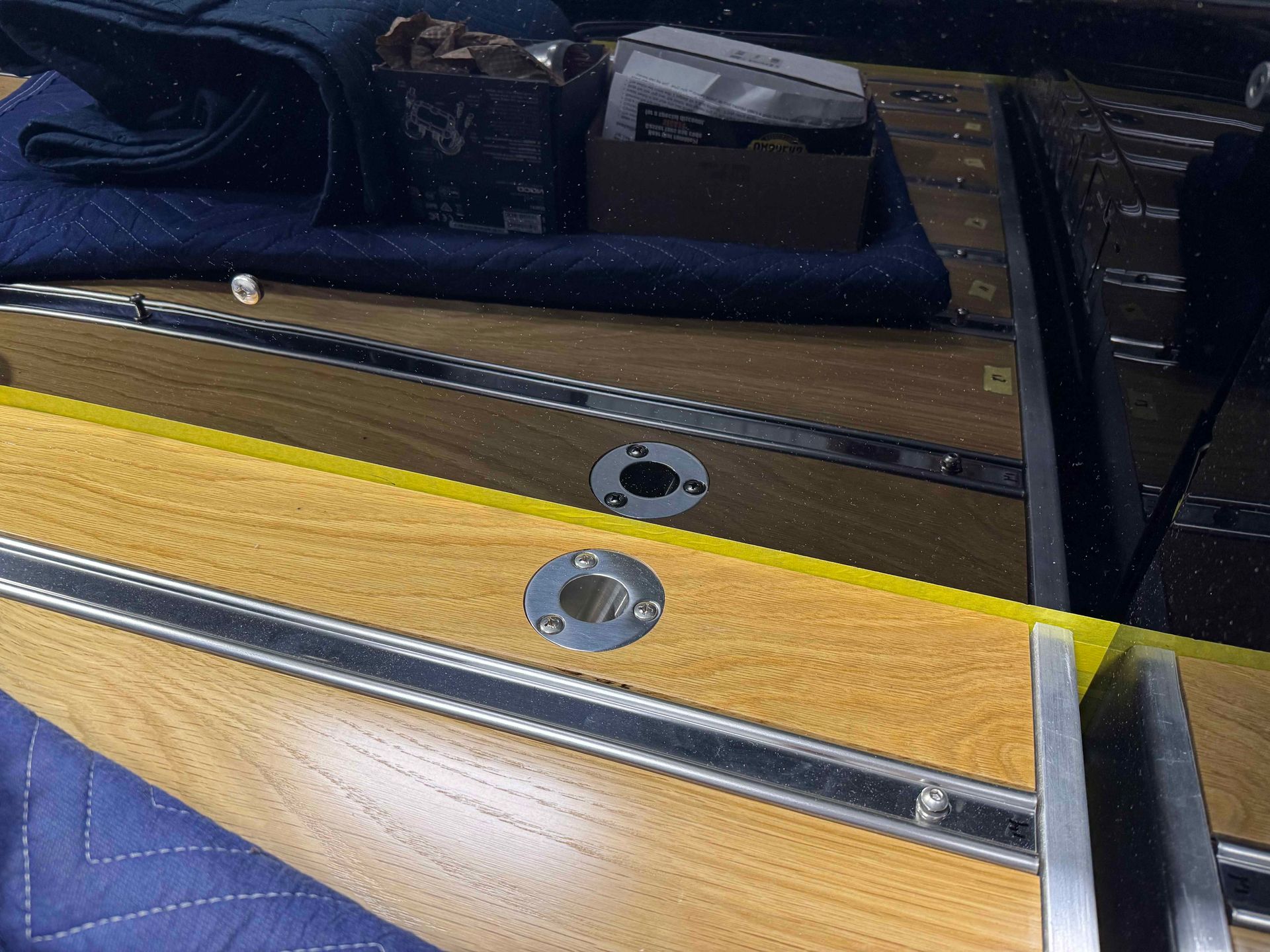 Close-up of yellow and wood ski bases with metal bindings inside a storage bag