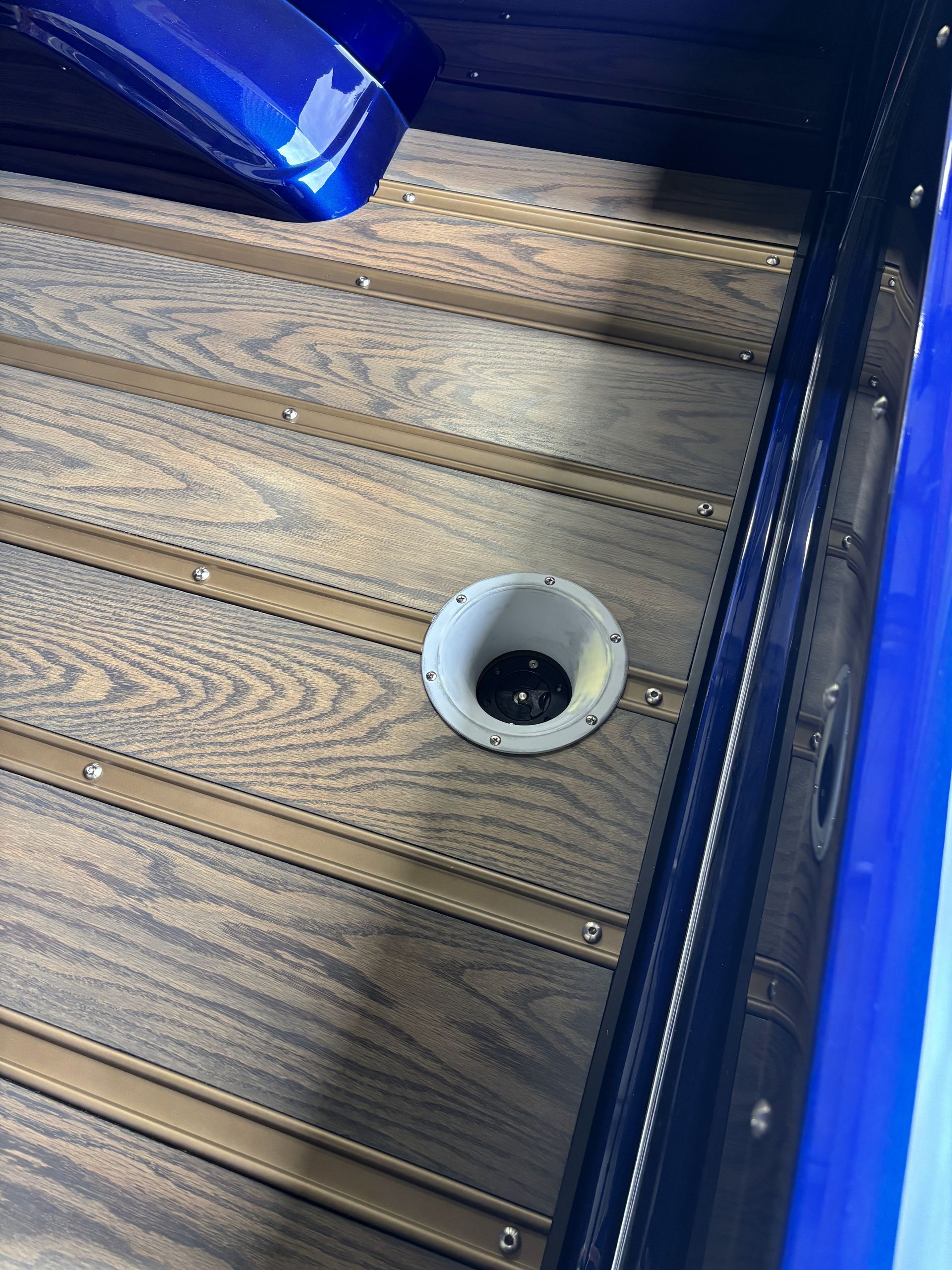 Blue lit steps with a small round drain or light fixture in the center.