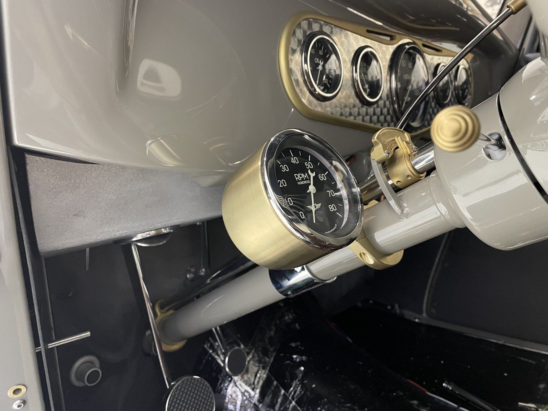 Close-up of vintage aircraft cockpit gauges and control panel with cream and black dials