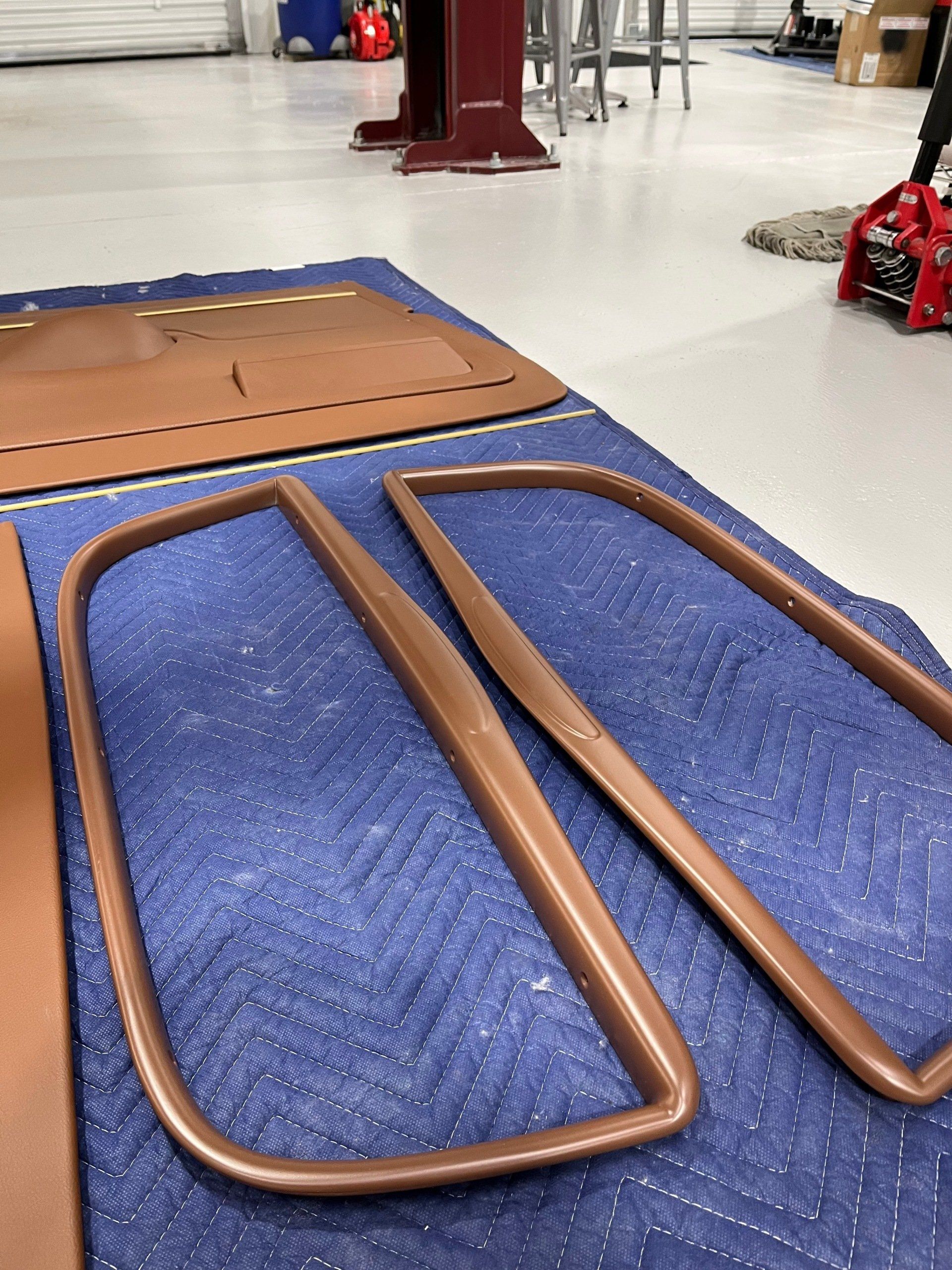 Blue and tan floor mats laid out in a workshop or gym space